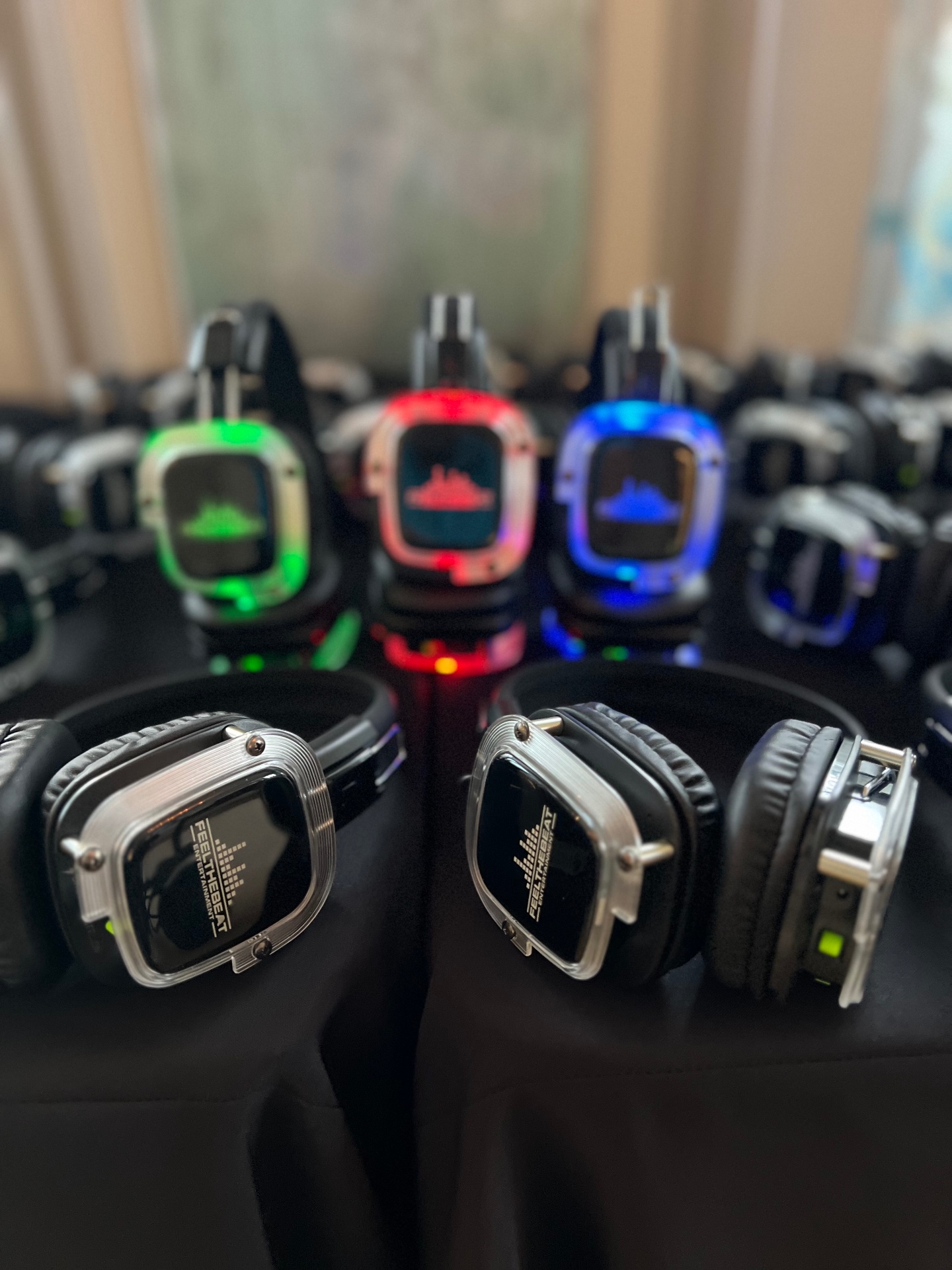 Silent disco LED headphones glowing green, red, and blue